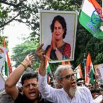 Congress activists carrying posters shout slogans during a protest rally in Kolkata on August 12, 2025, to condemn alleged electoral malpractices and the Special Intensive Revision (SIR) of electoral rolls.