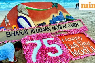Sand artist Sudarsan Pattnaik makes a sand sculpture of Prime Minister Narendra Modi