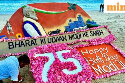Sand artist Sudarsan Pattnaik makes a sand sculpture of Prime Minister Narendra Modi