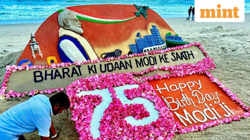 Sand artist Sudarsan Pattnaik makes a sand sculpture of Prime Minister Narendra Modi