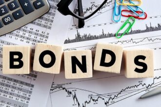 India bond yields inch down on quarter-end buying; RBI policy key