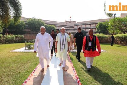 Prime Minister Narendra Modi walks along with Rashtriya Swayamsevak Sangh (RSS) Chief Mohan Bhagwat and others as he arrives to pay tribute at RSS
