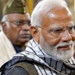 Prime Minister Narendra Modi and Congress chief Mallikarjun Kharge (in the background)
