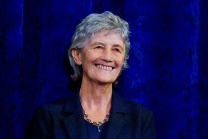 President-elect Catherine Connolly reacts as she stands on a stage at Dublin Castle, on the day of the announcement of the results of the Irish presidential election in Dublin, Ireland, October 25, 2025.