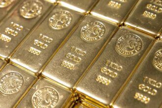 Gold slips as Fed rate caution boosts dollar, set for 3rd monthly rise