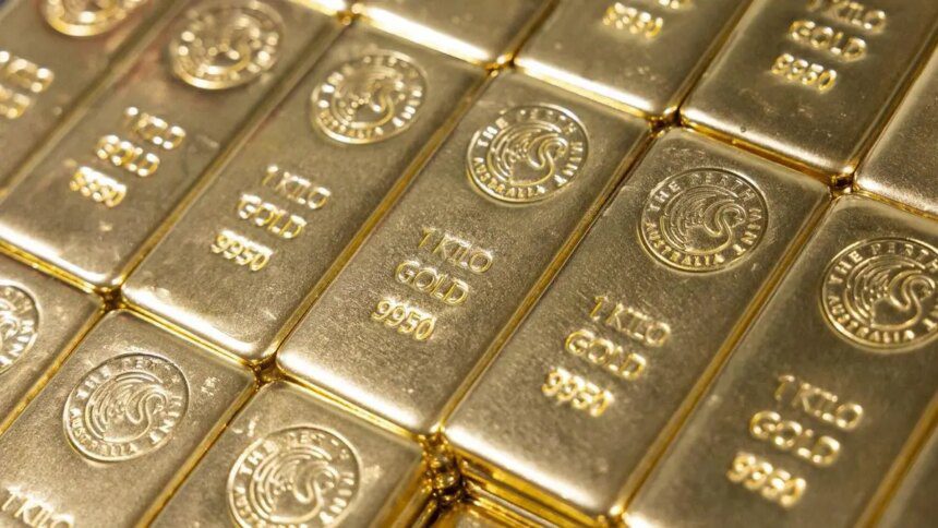 Gold slips as Fed rate caution boosts dollar, set for 3rd monthly rise