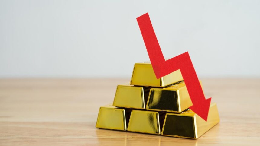 Gold edges lower as dollar gains, traders pare down US rate cut bets