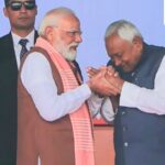 Prime Minister Narendra Modi being greeted by Nitish Kumar after taking oath as the Chief Minister of Bihar during the swearing-in ceremony, at Gandhi Maidan in Patna.
