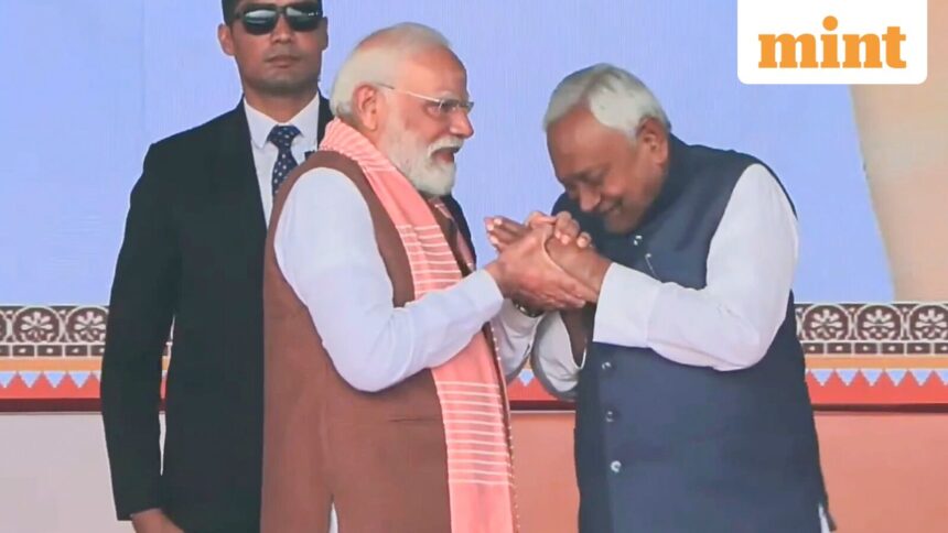 Prime Minister Narendra Modi being greeted by Nitish Kumar after taking oath as the Chief Minister of Bihar during the swearing-in ceremony, at Gandhi Maidan in Patna.