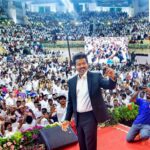 Newly-elected Tamil Nadu Chief Minister and Tamilaga Vettri Kazhagam (TVK) chief C Joseph Vijay takes a selfie with the gathering during his swearing-in ceremony, at Jawaharlal Nehru Stadium, in Chennai, Sunday, May 10, 2026. (PTI Photo)