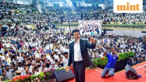 Newly-elected Tamil Nadu Chief Minister and Tamilaga Vettri Kazhagam (TVK) chief C Joseph Vijay takes a selfie with the gathering during his swearing-in ceremony, at Jawaharlal Nehru Stadium, in Chennai, Sunday, May 10, 2026. (PTI Photo)
