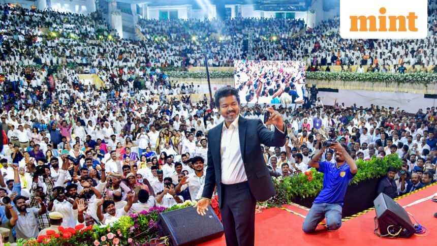 Newly-elected Tamil Nadu Chief Minister and Tamilaga Vettri Kazhagam (TVK) chief C Joseph Vijay takes a selfie with the gathering during his swearing-in ceremony, at Jawaharlal Nehru Stadium, in Chennai, Sunday, May 10, 2026. (PTI Photo)