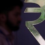 Rupee sinks to a record low