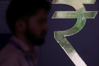 Rupee sinks to a record low