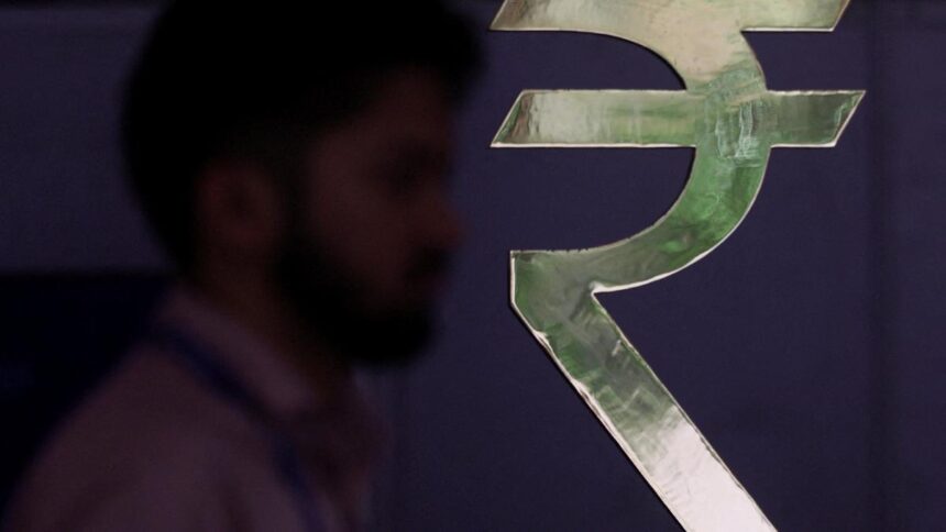 Rupee sinks to a record low