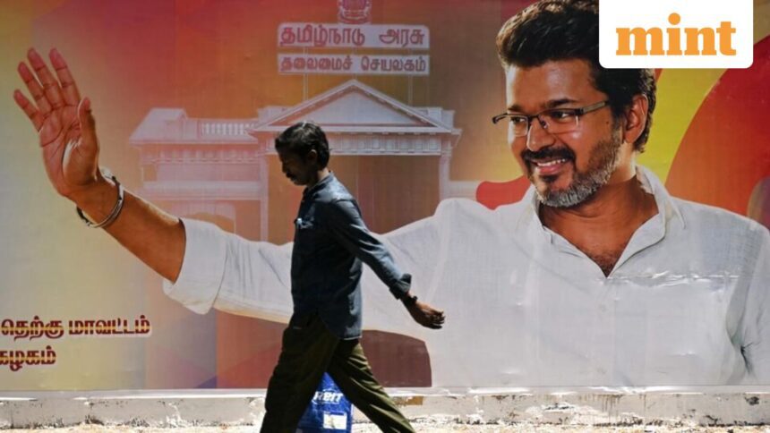 A man walks past a poster praising the victory of actor and Tamilaga Vettri Kazhagam (TVK) party president C. Joseph Vijay in Chennai on May 7, 2026 after the Tamil Nadu assembly election results were announced on May 4 (AFP)